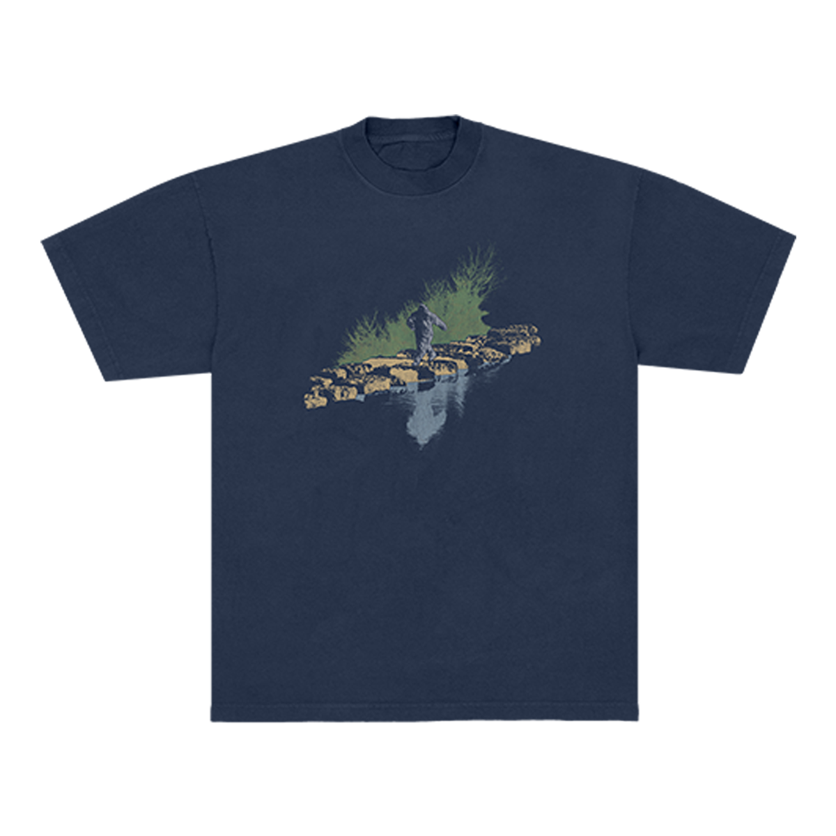 Navy Blue t-shirt with a graphic design of a Sasquatch walking on rocks with grass behind it and a water refection in front. 