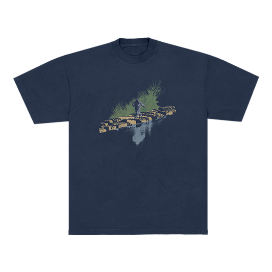 Navy Blue t-shirt with a graphic design of a Sasquatch walking on rocks with grass behind it and a water refection in front. 